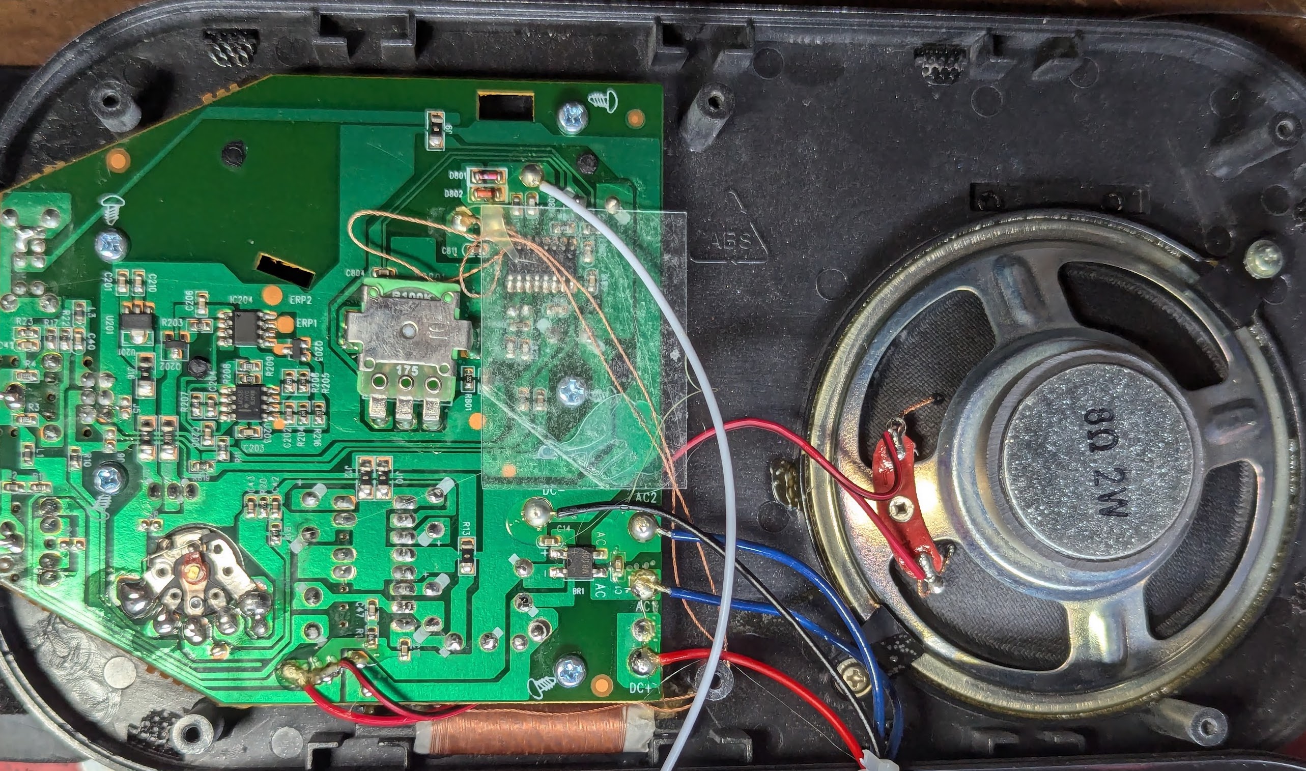 Inside the front of the case - a small transformer and some glue