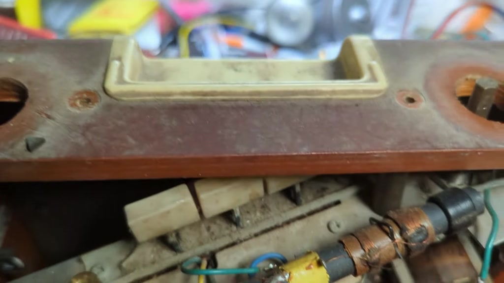 You need to pull off the volume control, knob and the tuning knob too to get the chassis out